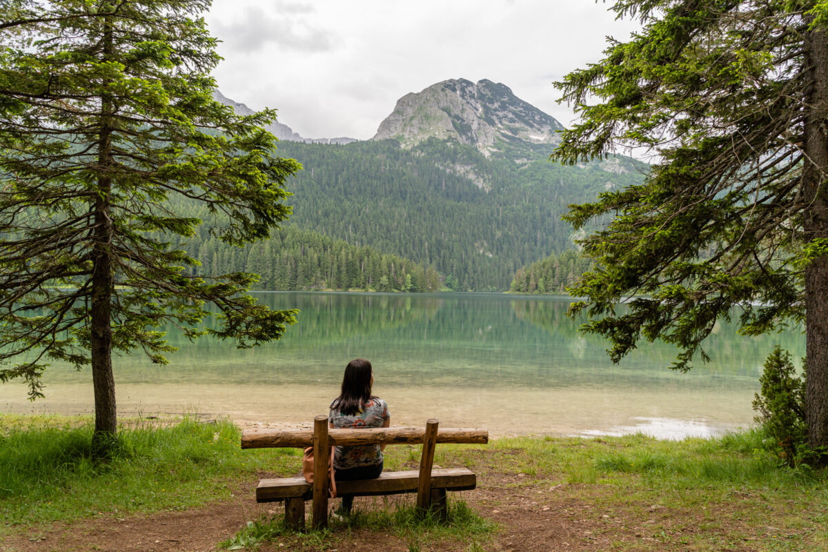 Female Sitting On A Wooden Bench In Durmitor National Park, Montenegro